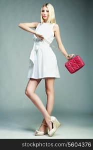 Fashion photo of young magnificent woman. Girl with handbag. Girl posing