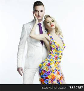 Fashion photo of young man and beautiful lady in flower dress