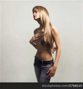 Fashion photo of young sensual woman in jeans