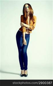 Fashion photo of young sensual woman in jeans. Studio photo