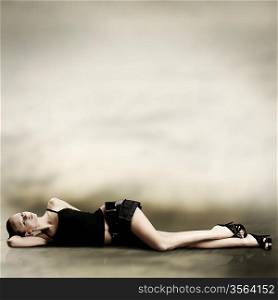 Fashion photo. Young woman lays on floor