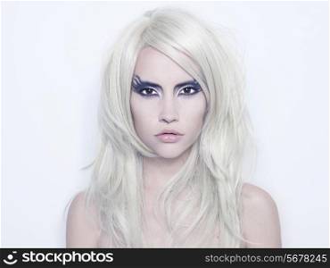 Fashion photography of beautiful young woman with fantasy makeup