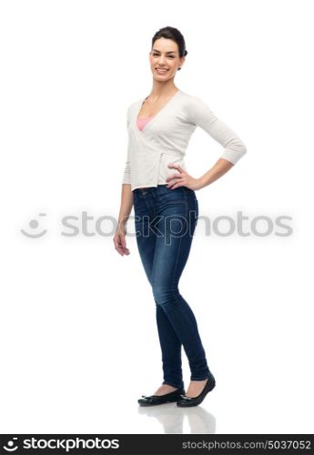 fashion, portrait and people concept - happy smiling young woman in cardigan and jeans. happy smiling young woman in cardigan