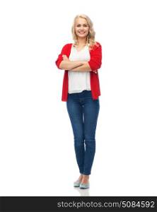 fashion, portrait and people concept - happy smiling young woman in red cardigan and jeans. happy smiling young woman in red cardigan. happy smiling young woman in red cardigan