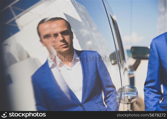 Fashion portrait of a handsome man in blue suit
