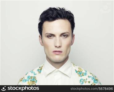 Fashion portrait of a handsome young man with make-up