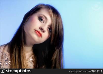 fashion portrait of a woman face with beautiful long natural hair. Blue background