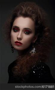 Fashion portrait of a woman with high hair and red lips. Photo shoot in the studio.