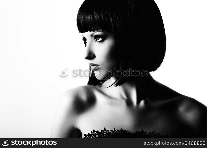 Fashion portrait of a young beautiful dark-haired woman. Black and white photo