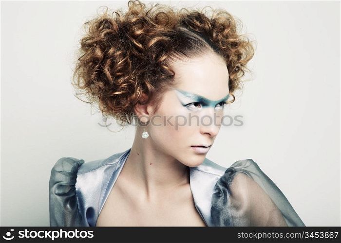 Fashion portrait of a young beautiful redhead woman