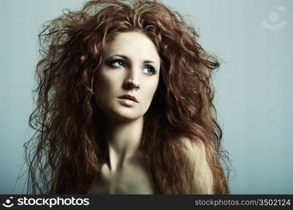 Fashion portrait of a young beautiful redheaded woman