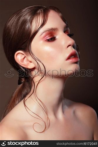 Fashion portrait of a young woman with bright makeup.