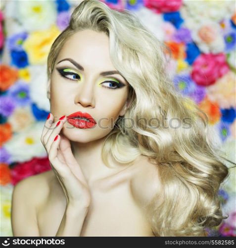 Fashion portrait of beautiful blonde on flower background