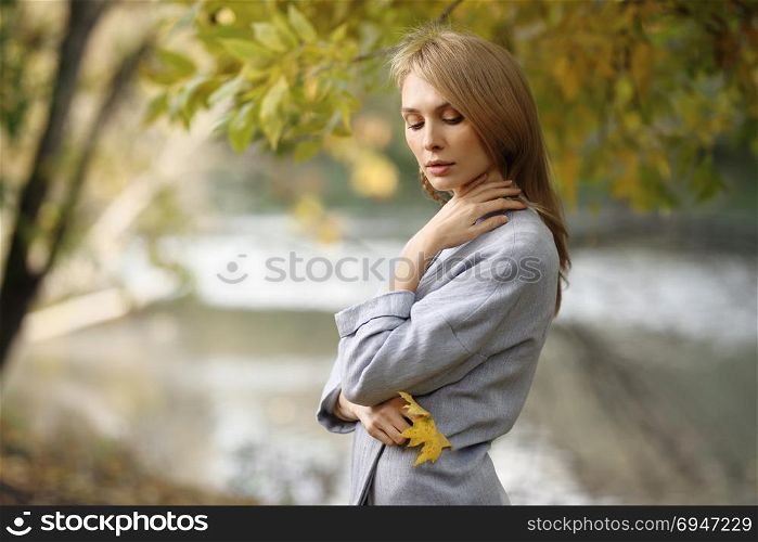 Fashion portrait of beautiful blonde woman in stylish clothes outdoor in autumn.. Fashion portrait of beautiful blonde woman in stylish clothes outdoor in autumn