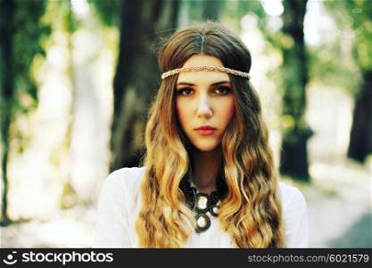 Fashion portrait of beautiful hippie young woman wearing boho chic clothes and summer hat outdoors. Soft warm vintage color tone. Artsy bohemian style.