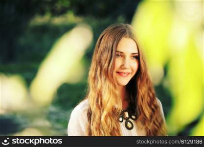 Fashion portrait of beautiful hippie young woman wearing boho chic clothes outdoors. Soft warm vintage color tone. Artsy bohemian style
