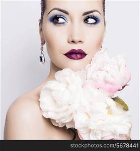 Fashion portrait of beautiful young lady with peonies