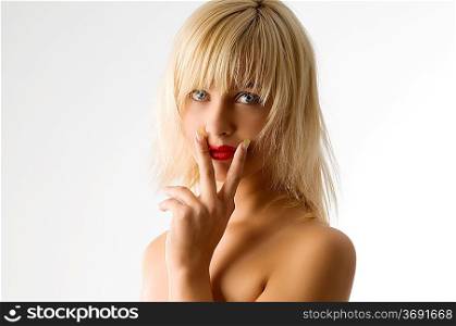 fashion portrait of blond girl with red lips between her fingers