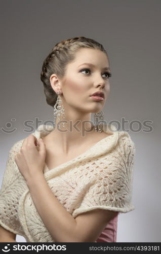 fashion portrait of elegant pretty girl with brown creative hair-style, precious earrings in emotional pose