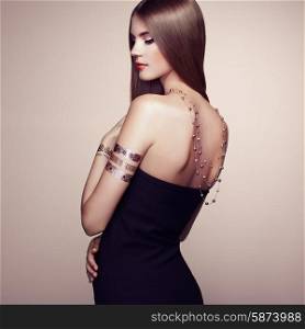 Fashion portrait of elegant woman with magnificent hair. Blonde girl. Perfect make-up. Girl in elegant dress. Flash tattoo gold