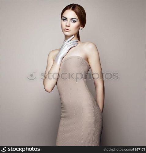 Fashion portrait of elegant woman with magnificent hair. Blonde girl. Perfect make-up. Girl in elegant dress. Girl posing. Studio photo