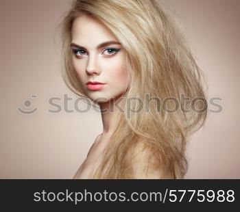 Fashion portrait of elegant woman with magnificent hair. Blonde girl. Perfect make-up. Hairstyle