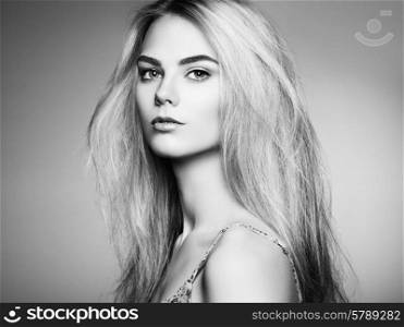 Fashion portrait of elegant woman with magnificent hair. Blonde girl. Perfect make-up. Hairstyle. Black and white