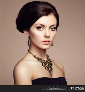 Fashion portrait of elegant woman with magnificent hair. Brunette girl. Perfect make-up