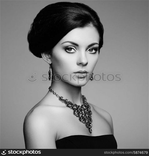 Fashion portrait of elegant woman with magnificent hair. Brunette girl. Perfect make-up. Black and white