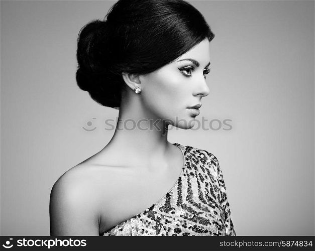 Fashion portrait of elegant woman with magnificent hair. Brunette girl. Perfect make-up. Black and white