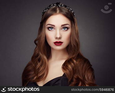 Fashion portrait of elegant woman with magnificent hair. Brunette girl. Perfect make-up. Girl in black dress. Curly hair