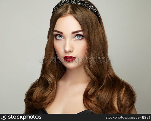 Fashion portrait of elegant woman with magnificent hair. Brunette girl. Perfect make-up. Girl in black dress. Curly hair