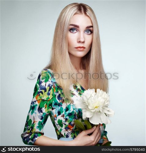 Fashion portrait of elegant woman with summer flowers. Blonde girl. Perfect make-up. Hairstyle. Summer dress. Peonies