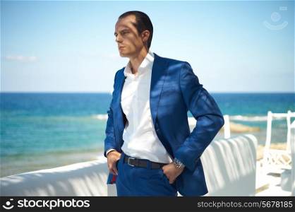 Fashion portrait of handsome man in blue suit