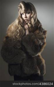 fashion portrait of sensual blonde female with long hair, pretty make-up and creative hair-style wearing elegant fur coat and looking in camera &#xA;