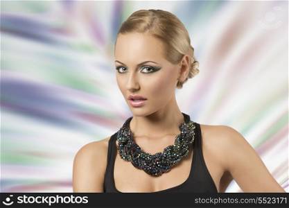 fashion portrait of sexy blonde girl with elegant hair-style, cute make-up, dark dress and big beads necklace
