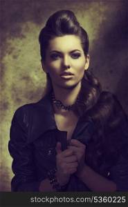 fashion portrait of sexy modern woman with long brown wavy creative hair-style, dark rock style wearing leather jacket