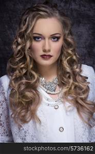 fashion portrait of splendid blonde curly woman with vintage elegant white clothes, precious necklace and stylish make-up. Aristocratic lady
