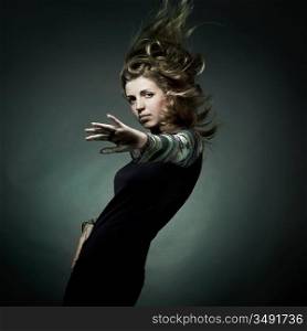 Fashion portrait of the beautiful woman with flying hair