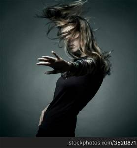 Fashion portrait of the beautiful woman with flying hair