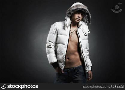 Fashion portrait of the young beautiful man in a white jacke