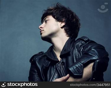 Fashion portrait of the young beautiful man in studio