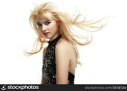 Fashion portrait of the young blonde woman with flying hair