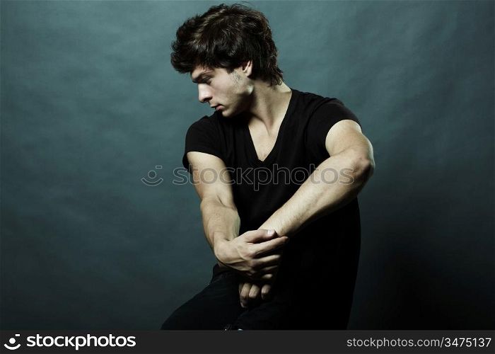 Fashion portrait of the young sexual man in studio