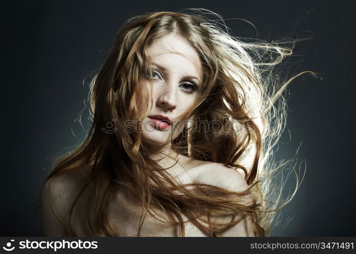 Fashion portrait of the young sexy woman with flying hair