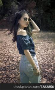 fashion portrait of young asian woman with amazing hair outdoor