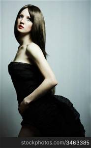 Fashion portrait of young beautiful elegant woman in the black dress