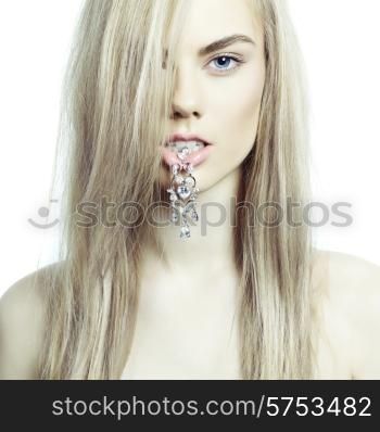 Fashion portrait of young beautiful lady with an earring in her mouth
