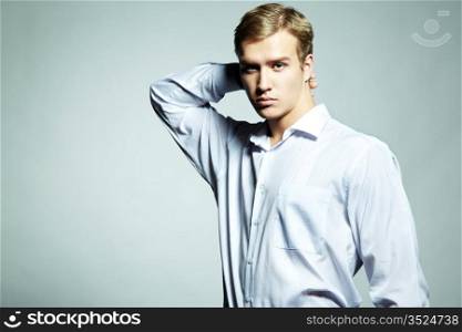 Fashion portrait of young beautiful man on a white background