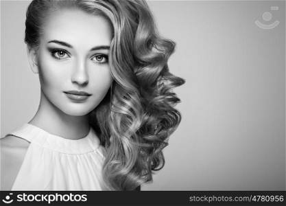 Fashion portrait of young beautiful woman with jewelry and elegant hairstyle. Blonde girl with long wavy hair. Perfect make-up. Beauty style woman with diamond accessories. Black and White